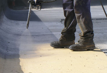 Coating systems over Wilmington spray foam roof systems